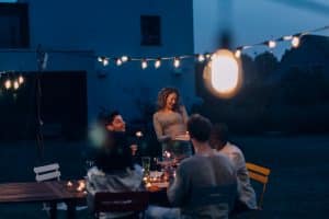 friends celebrate birthday at a summer backyard dinner